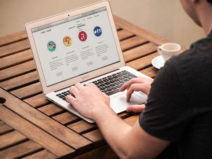 Man browsing the web on a Macbook Air