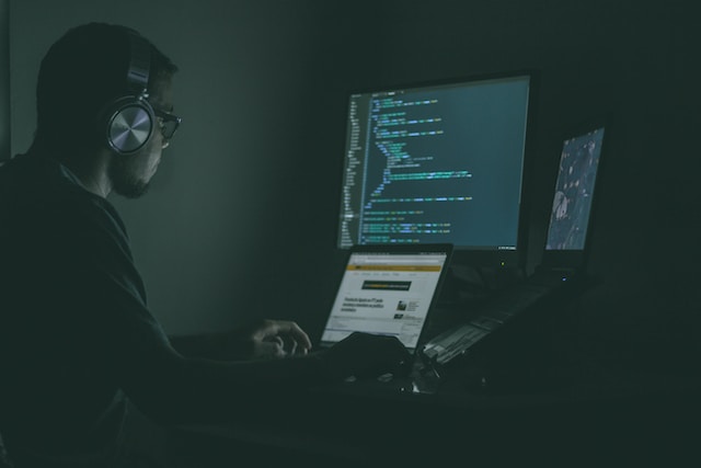 Web Developer working in a dark room